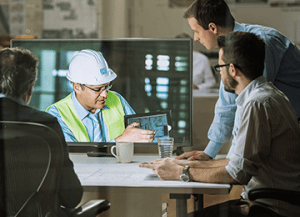 Engineering team discussing a design with a colleague on a video call