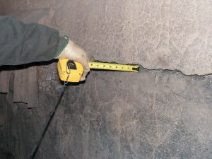 Engineer using infrared thermography to detect hot spots in a furnace refractory lining.