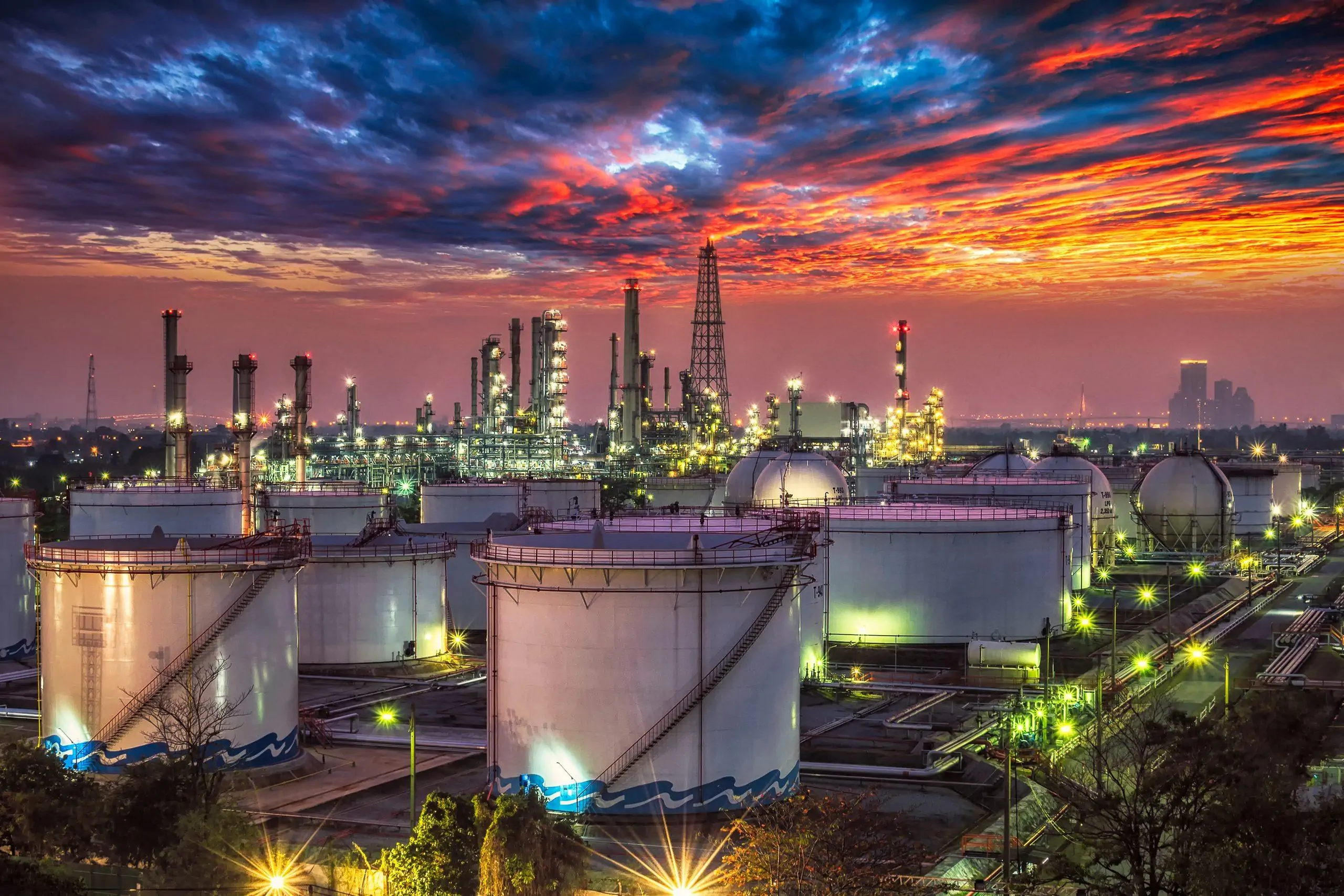 Chemical processing plant and storage tanks illuminated at dusk