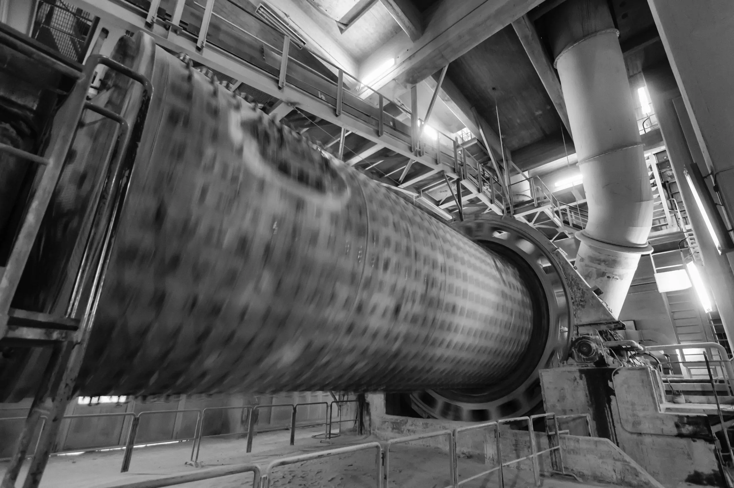 Large rotating industrial kiln inside a processing building