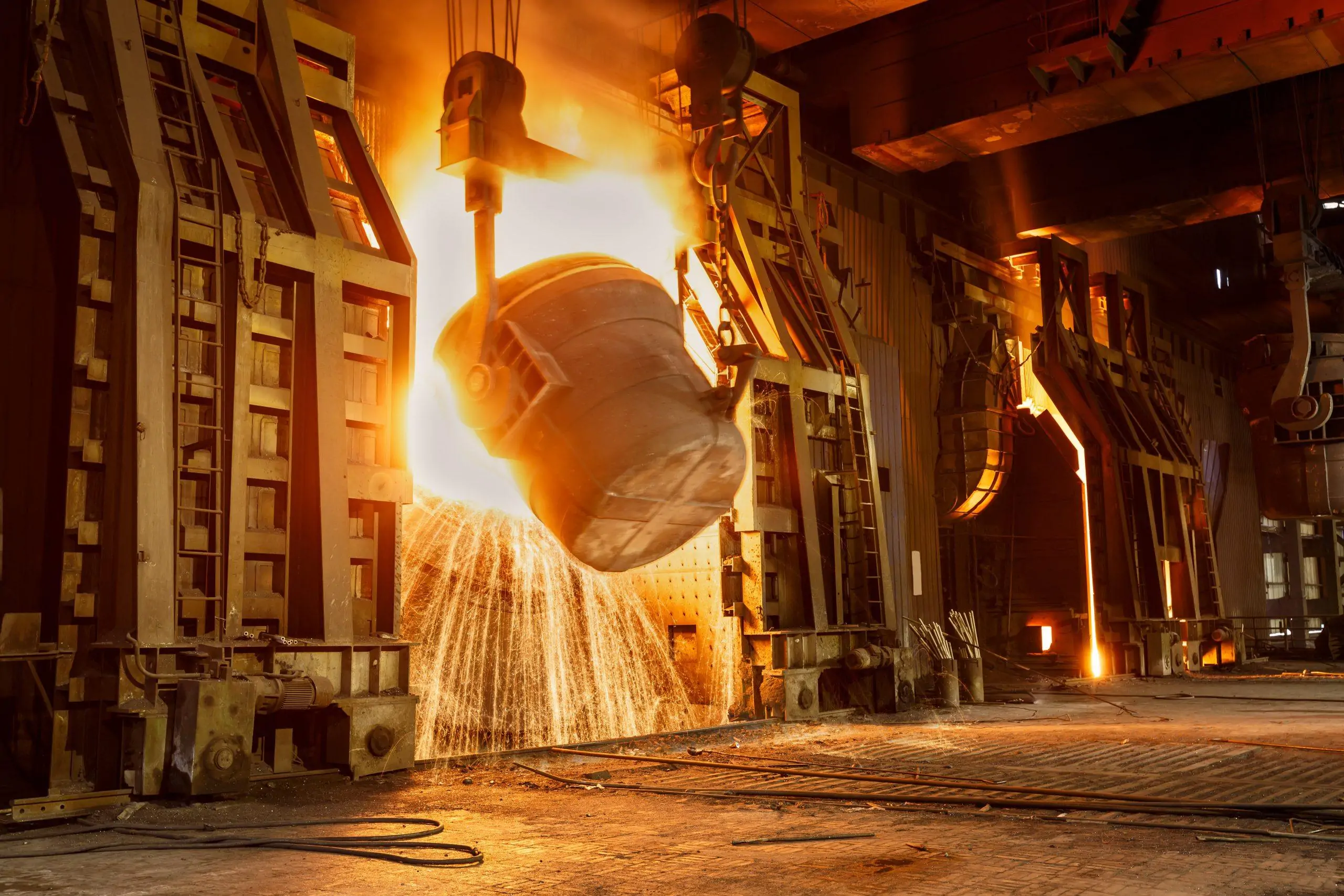 Steel ladle pouring molten metal inside a steelworks